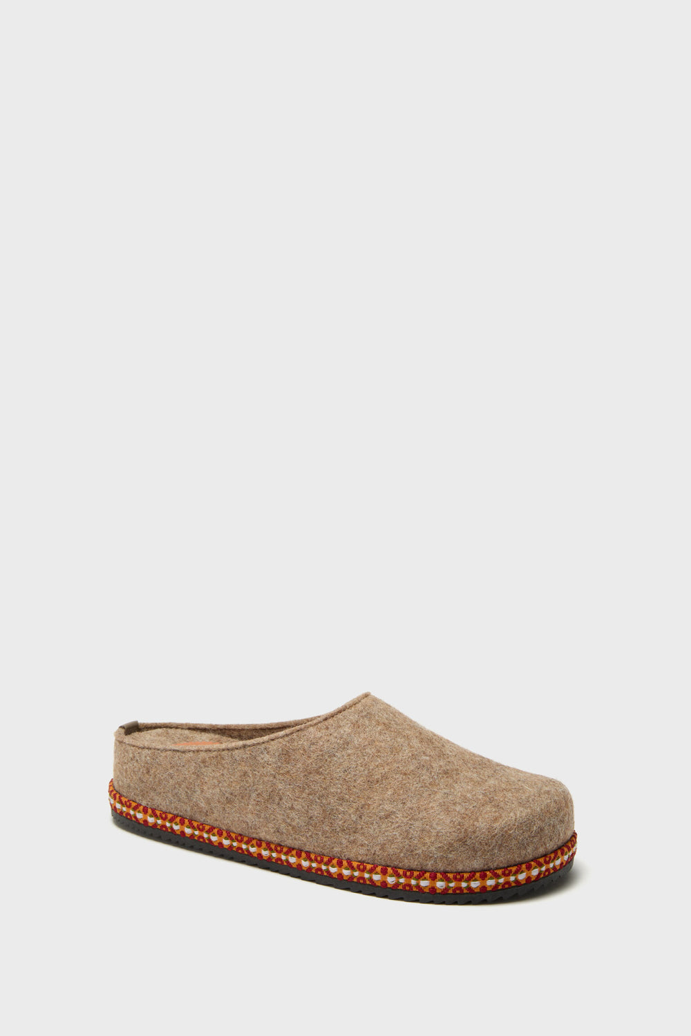 The Penelope Chilvers slipper is a single brown wool felt design with a dark rubber sole and decorative trim—perfect for cozying up at home.