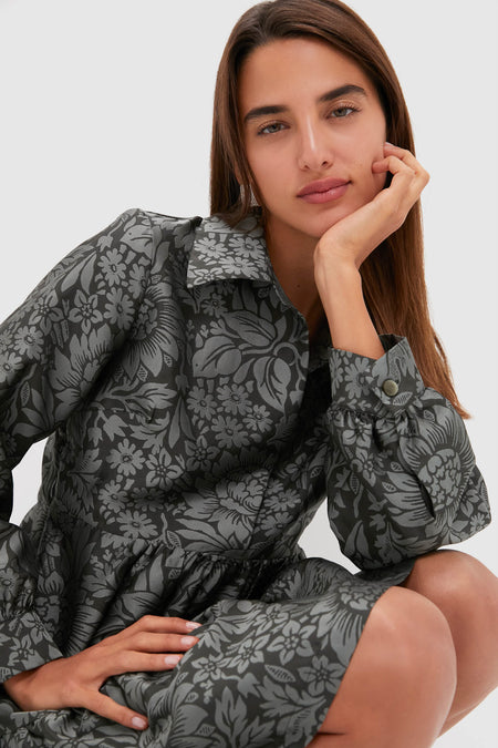 Young woman models the classic Emerald Mirasol Jacquard Alette Dress, showcasing its effortless elegance with a vintage-inspired botanical pattern and slightly puffed sleeves. Perfect for high-end occasions.