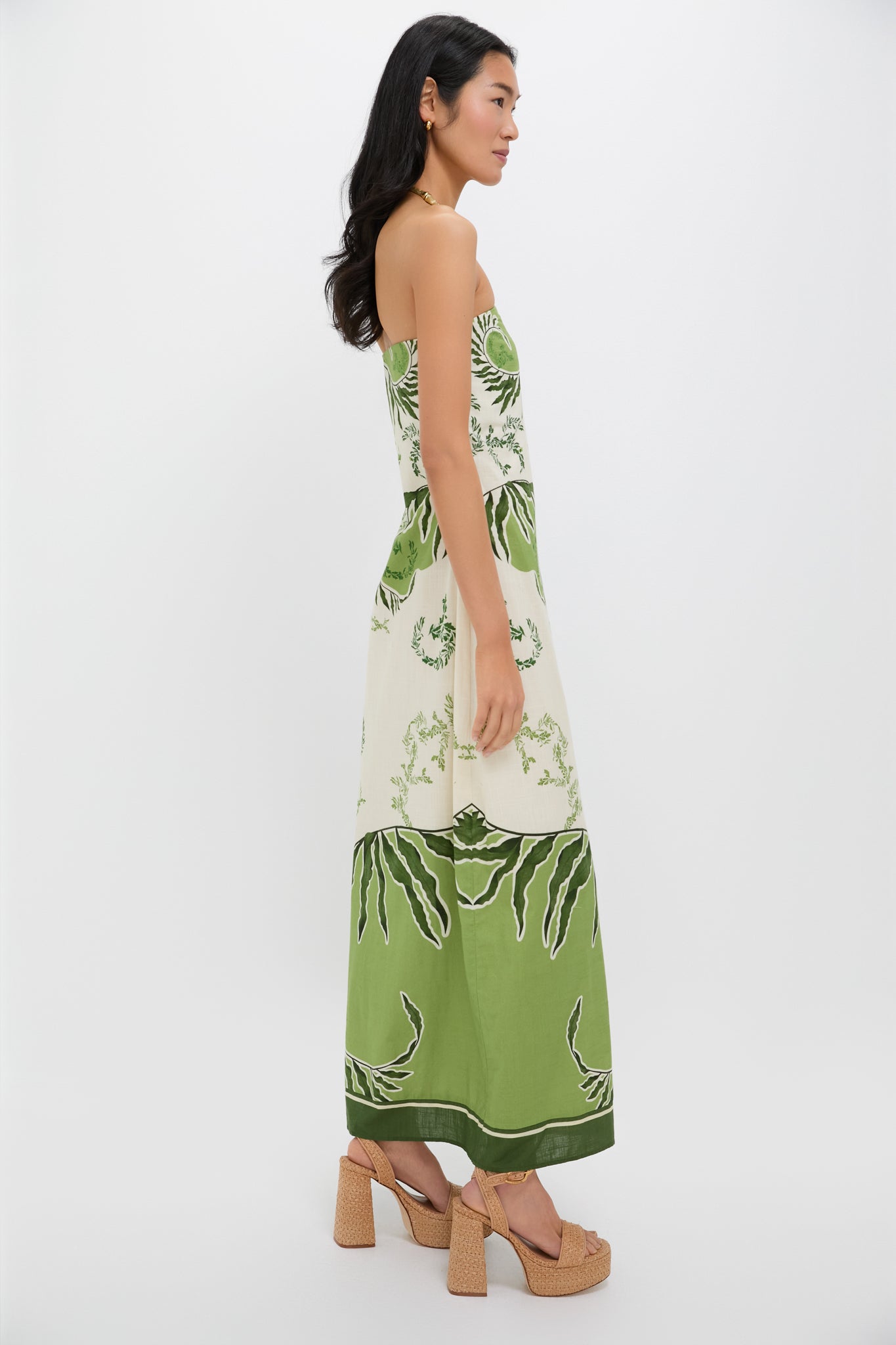 Ireland Green Wess Midi Dress: Strapless, elegant botanical print with a chic side slit. Perfect for effortless, high-end style, paired with tan sandals and gold jewelry.