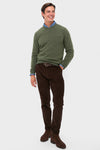 Man modeling the classic Olive Essential Patch Crew Neck Sweater with leather elbow patches, layered over a shirt, paired with corduroy trousers and Chelsea boots for an effortless, high-end look.