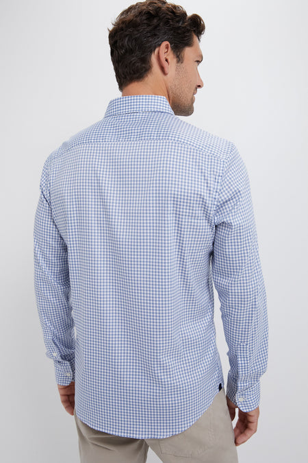 Model wearing the Light Blue Gingham Movement Shirt, showcasing its classic, effortless design with buttoned cuffs, curved hem, and high-end stretch fabric for fun, versatile styling.