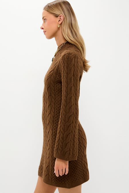 Model in Coffee Cable Knit Lucia Mini Dress, showcasing classic, effortless style with a mock neck and flared sleeves, accessorized with gold jewelry for a high-end look.