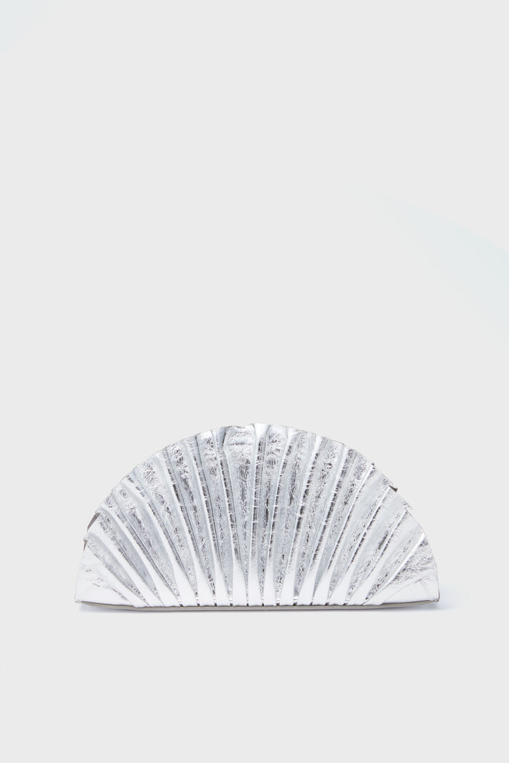 The Cult Gaia Silver Nala Mini Clutch is a metallic silver, semi-circular bag with a pleated, fan-like texture and an elegant shell-shaped design.