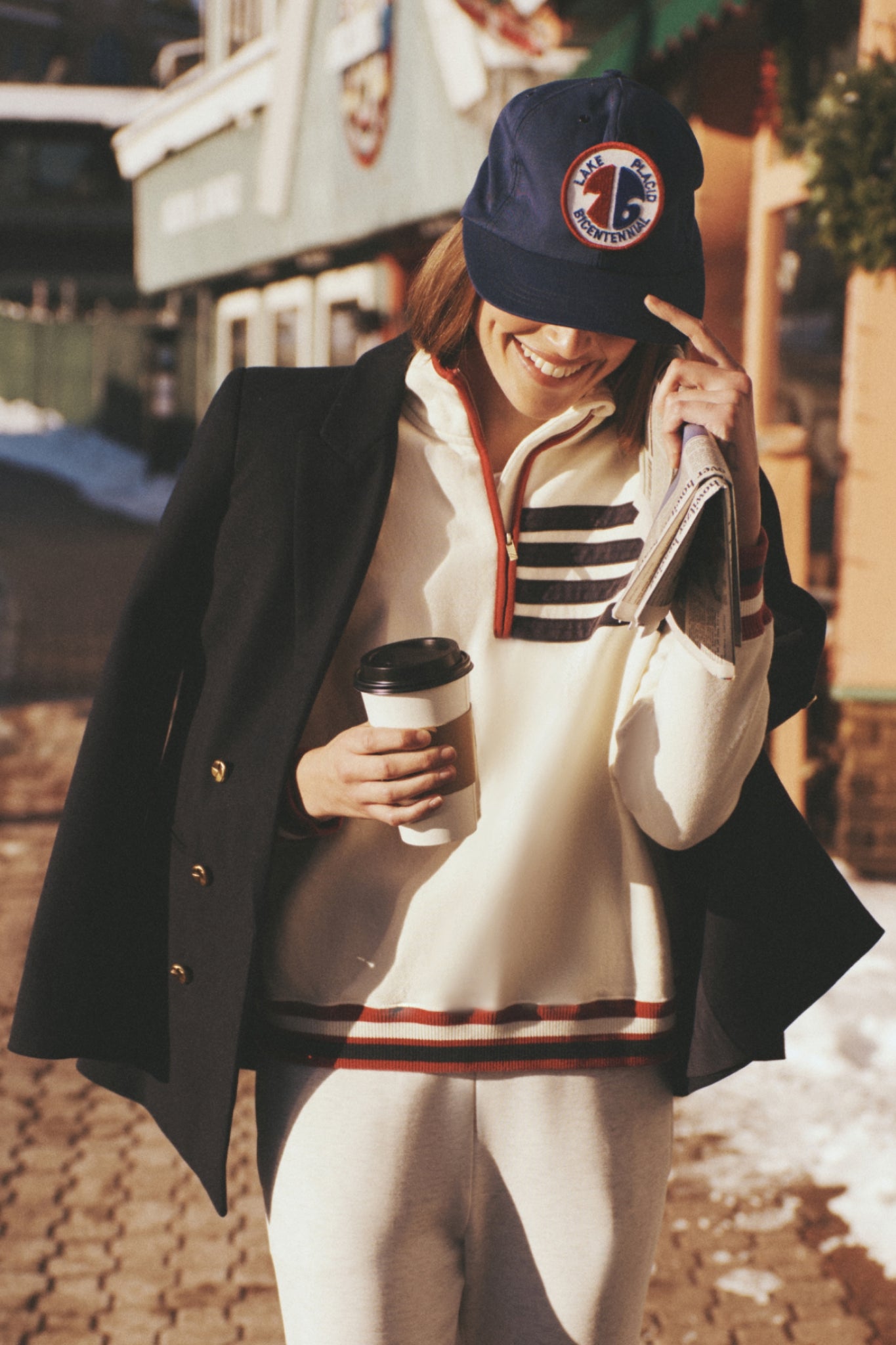 Person outside in casual wear, sporting the Navy Diana Blazer over shoulders. The blazer's classic, high-end style exudes effortless, fun elegance with its oversized, tailored fit.