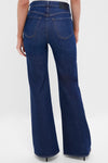 Back view of the Madison Kimberly 70's Flare jeans, showcasing classic high-rise, effortless flare over heels, embodying fun, high-end style with a vintage-inspired silhouette.