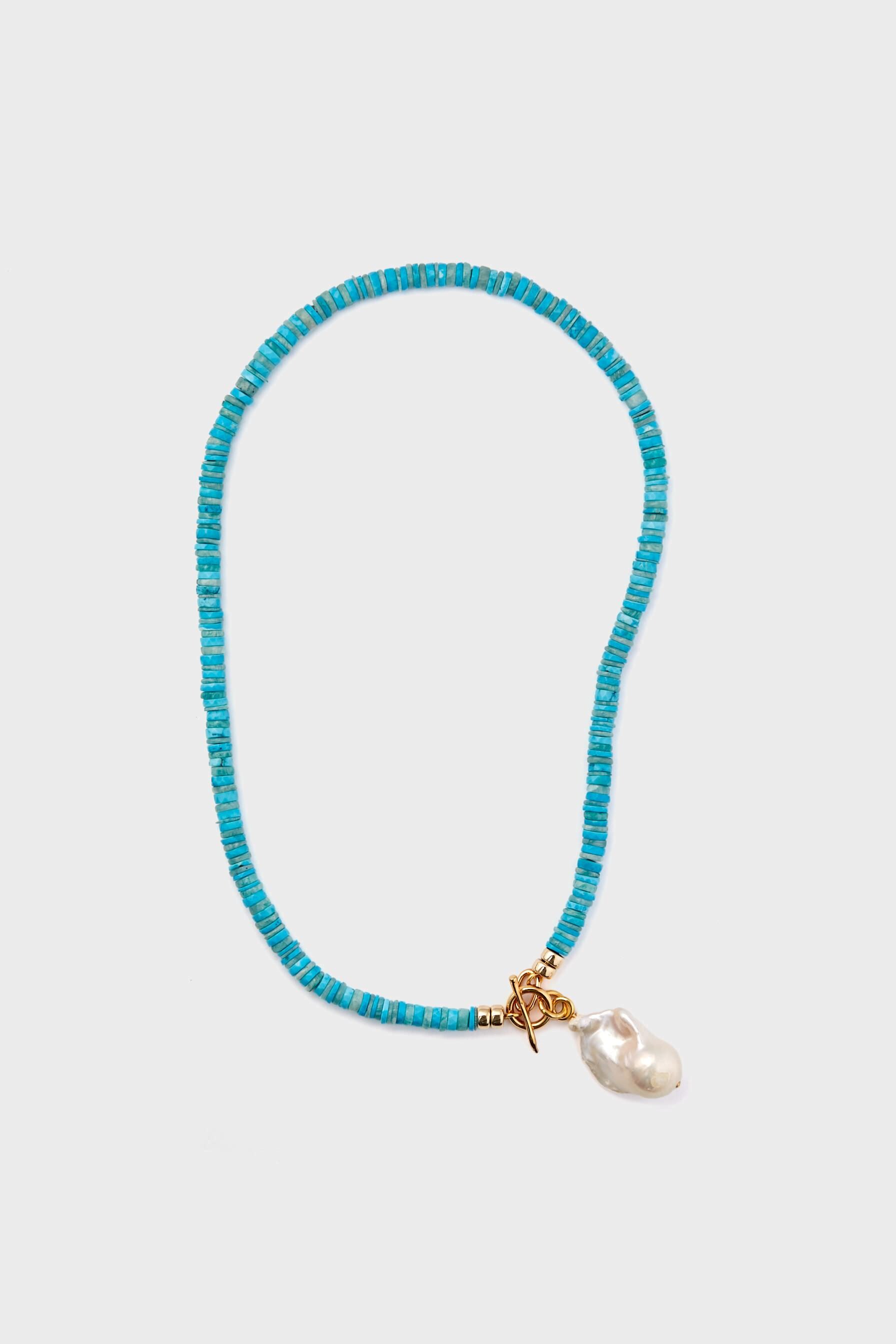 The Lizzie Fortunato Turquoise Pearl Isle Necklace features a gold clasp, turquoise beads, and a single irregular freshwater pearl pendant.