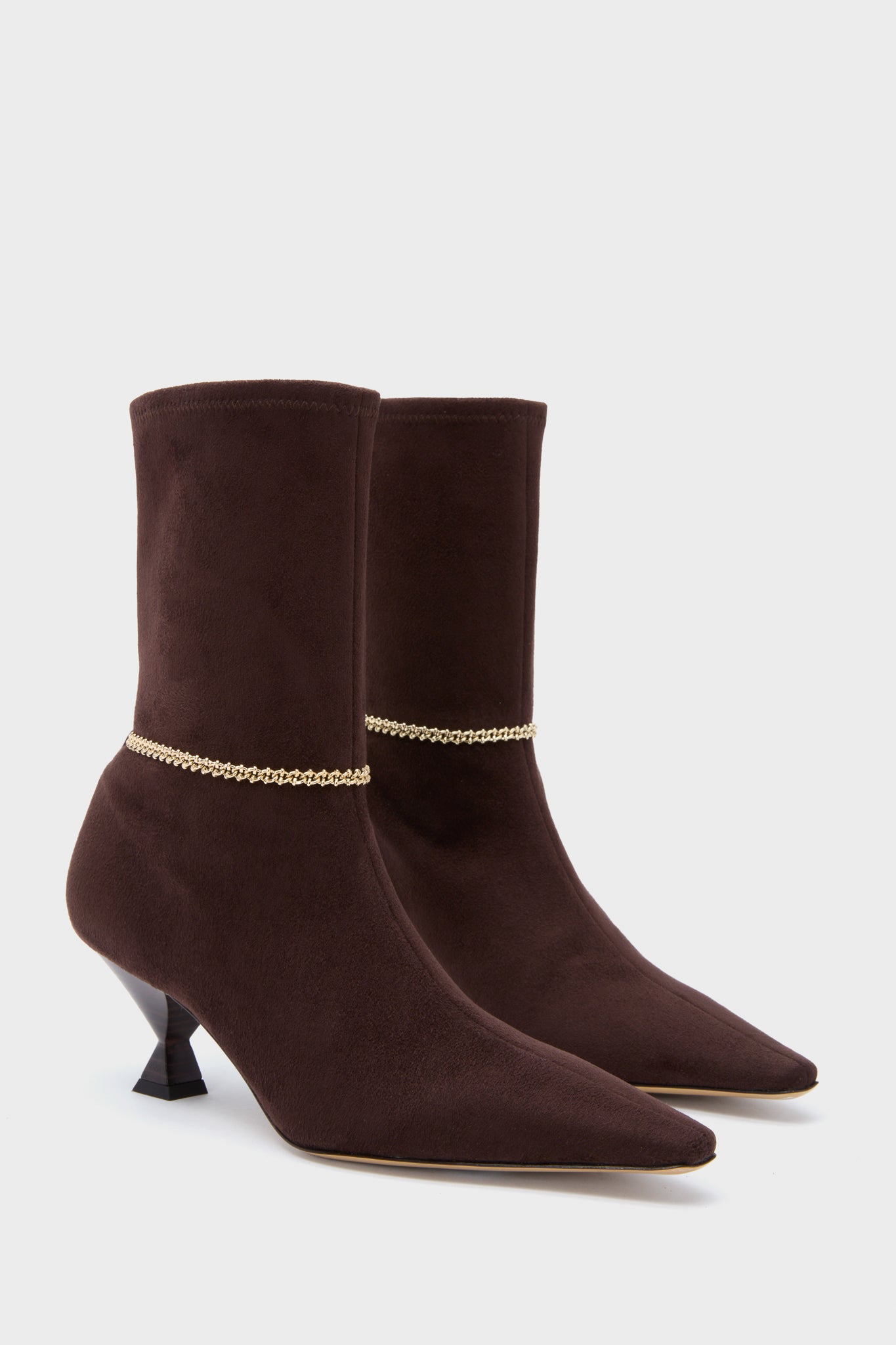 Maria Luca brown suede ankle boots with pointed toes, low heels, and gold chain detail around the ankles, shown on a plain white background.