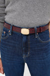 Merlot Jacob Croco Belt showcased with a classic light gray sweater and dark jeans, highlighting its high-end burgundy croc-embossed leather and effortless gold buckle for a fun, sophisticated touch.