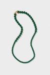Malachite Double Strand Celine Necklace features classic green beads and a gold-tone coil clasp for an effortless, high-end look. Wear it long or doubled for fun versatility.