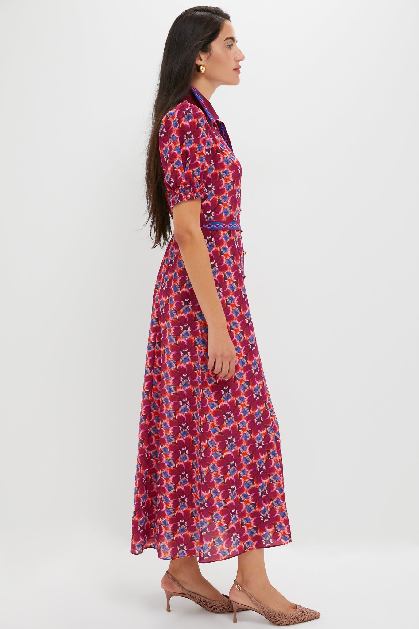 Woman in profile wearing the Quail Magenta Vanessa-D Midi Dress, a classic, effortlessly elegant floral shirt dress with short puffed sleeves and a narrow belt, paired with neutral sling-back pumps.