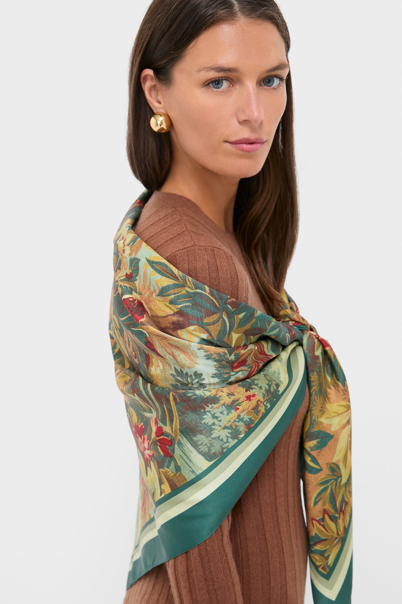 Model wearing the Forest Toile Large Scarf, a classic, high-end printed silk scarf. Effortlessly draped over shoulders, showcasing an oversized gold stud earring for a fun, chic look.