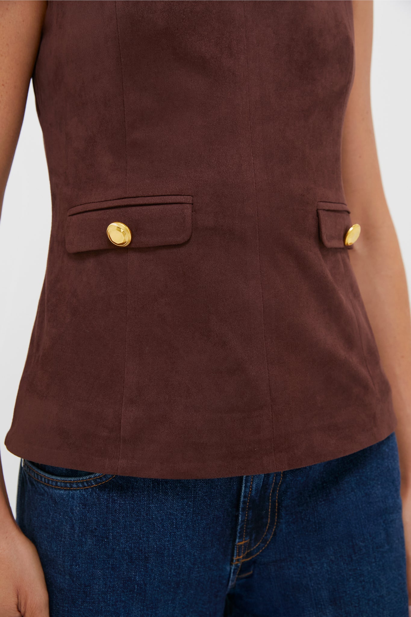 Brown Faux Suede Franz Top with high neckline, faux pockets with gold buttons, paired with blue denim jeans, embodies effortless, classic, high-end style for fall.