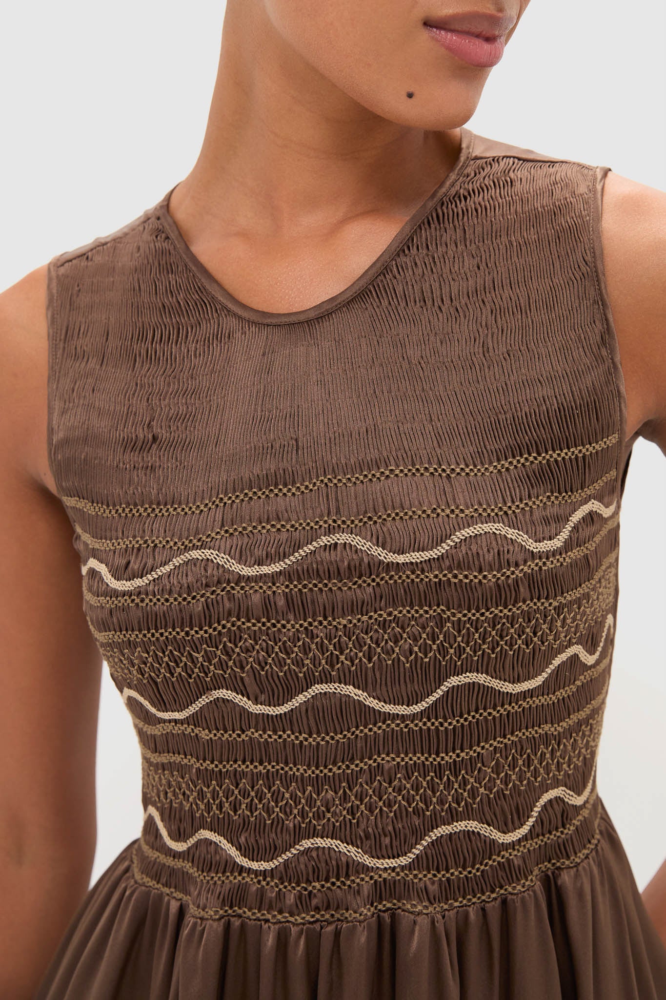 Regio Brown Silk Gioia Midi Dress on model, featuring a classic, effortless smocked bodice with contrast stitching and a fun, high-end flowy skirt.