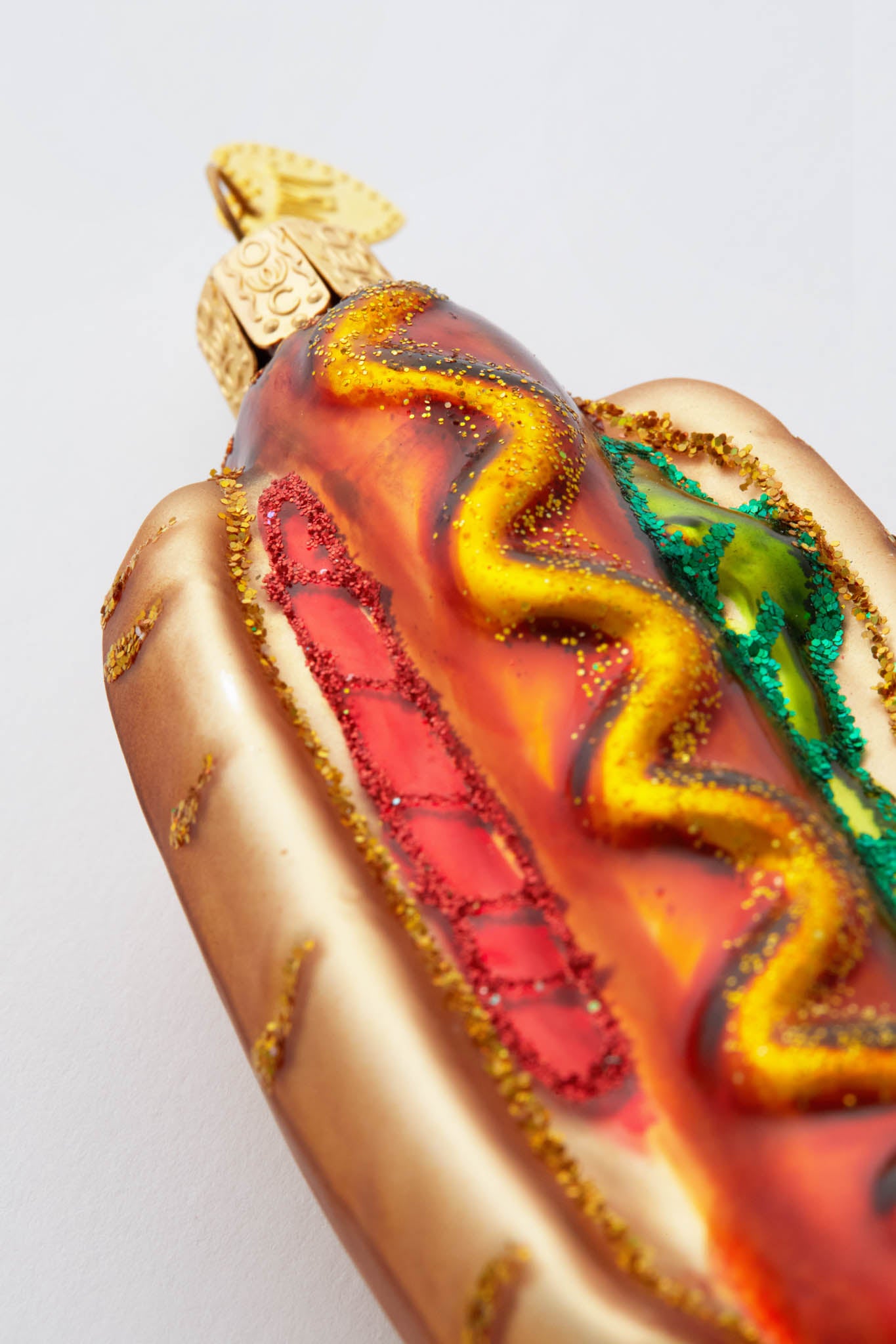 Classic Hot Dog Ornament: A fun, high-end glass ornament, hand-painted and glittered, with gold bun and condiments, perfect for an effortless and unique Christmas tree.