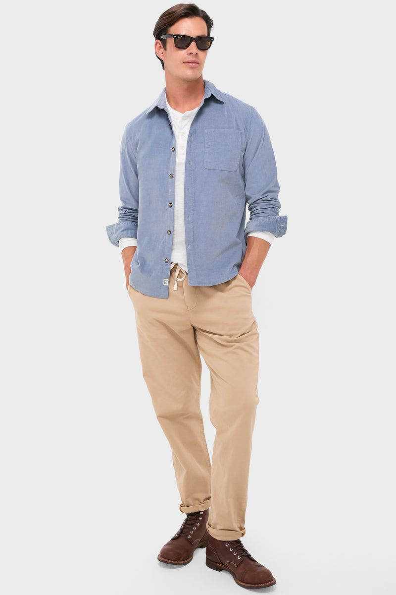 Man in Maritime Wilder Stretch Corduroy Shirt with classic flannel style, effortlessly paired with tan chinos and brown boots, embodying a fun, high-end, casual look.