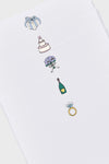 Dear Annabelle offers five sheets of white paper, each featuring a unique wedding-themed illustration—a gift box, cake, bouquet, champagne bottle, and diamond ring—perfect for wedding cards or bridal shower invitations.