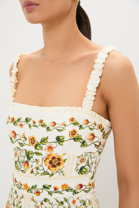 Uchuva Nispero Midi Dress with a square neckline, ruffled straps, and floral print embodies an effortless, classic style, perfect for a fun, high-end shopping experience.