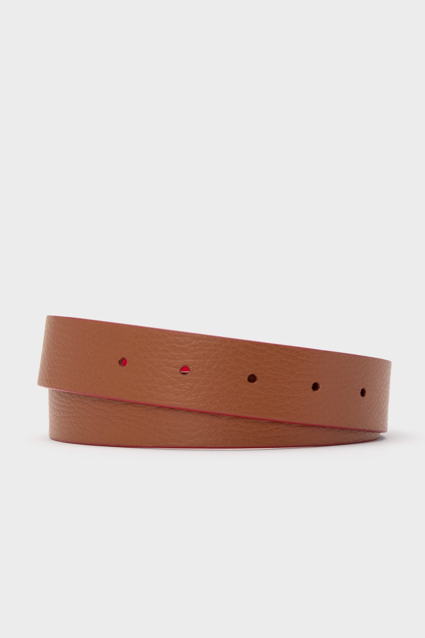 Maraschino and Biscotti Belt, a classic reversible leather strap with pebbled texture and red edge, offering effortless style and fun versatility for high-end, tailored looks.