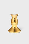 The AERIN gold-colored metallic candlestick holder features a wide base and rounded, tapered middle, adding artisanal elegance and craftsmanship to your home decor.