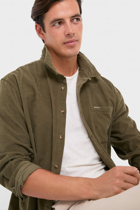 Man wearing an Olive Bramside Relaxed Cord Shirt, showcasing its classic, effortless design with rolled sleeves and soft texture, embodying high-end, fun style.