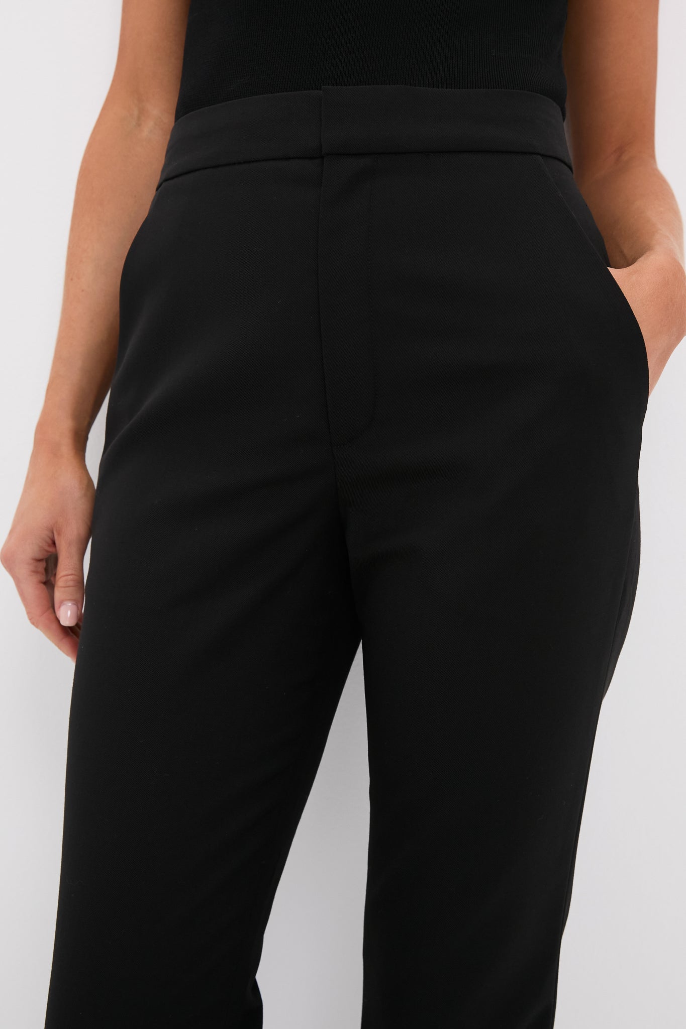 Person wearing Black Sophie II Pants, showcasing a classic, effortless high-end fit with flared legs and mid-rise waist, embodying fun, confident style.