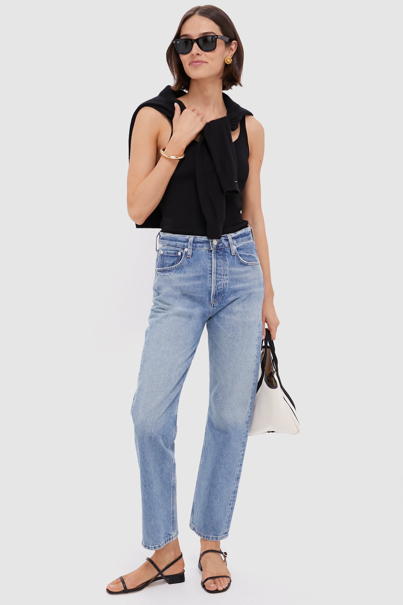 Woman models the Perri Blaine High Rise Straight jeans: classic, effortless style with a high-rise, straight-leg design, paired effortlessly with a chic top and accessories.