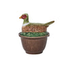 A Juliska ceramic container with a lid shaped like a pheasant perched on top and a wood grain-inspired base—ideal for ceramic bowls or adding charm to autumn tablescapes.