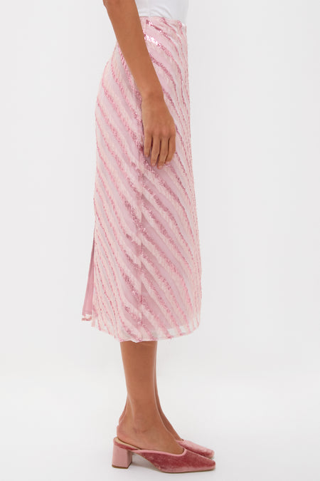 Soft Pink Shimmer Stripes Milan Midi Skirt features classic metallic diagonal stripes, paired effortlessly with pink velvet mules, embodying a fun and high-end, confident style.