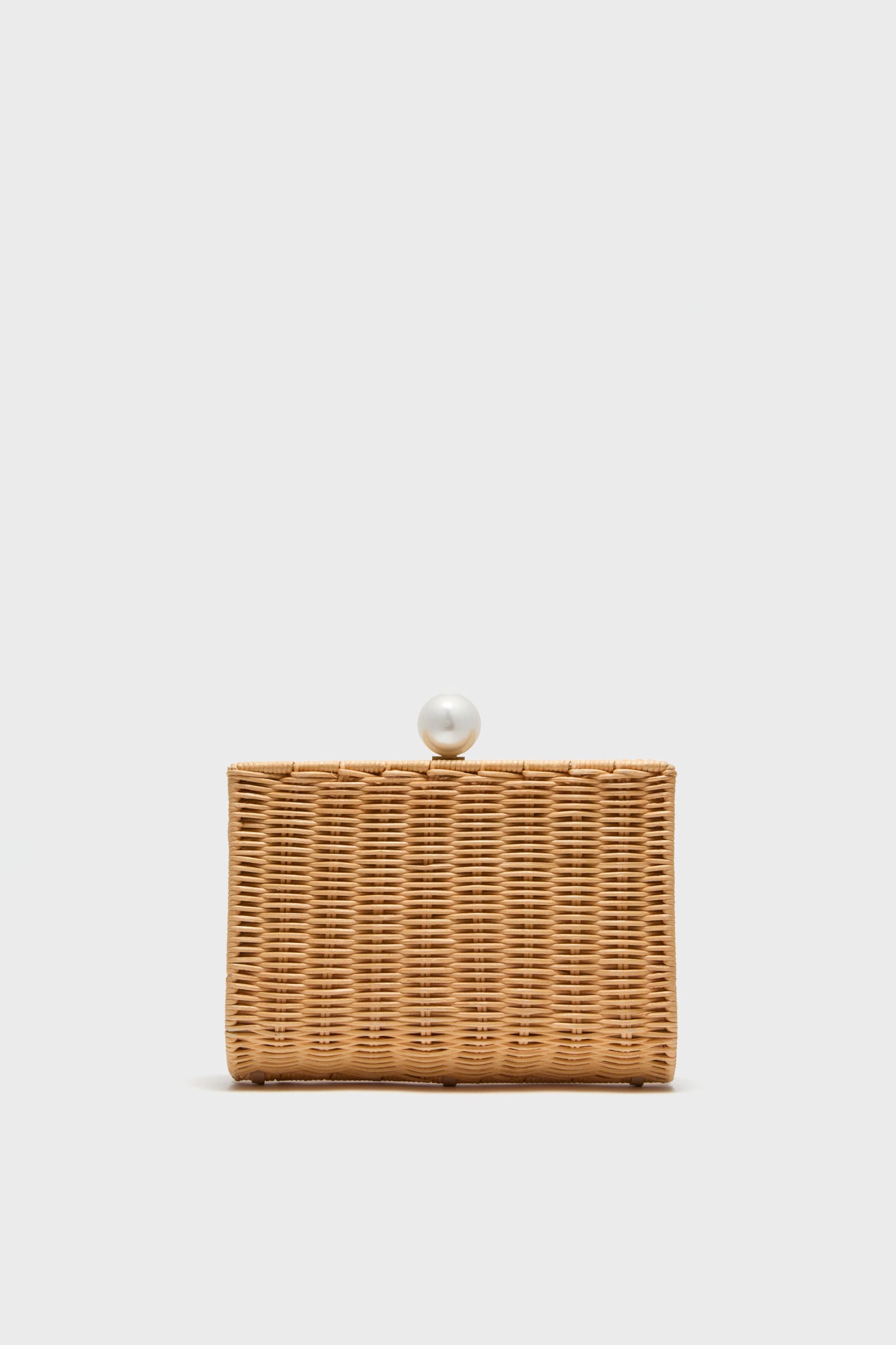 The Pamela Munson rectangular handwoven rattan clutch features a pearl clasp, making it an elegant addition to your straw accessories collection.