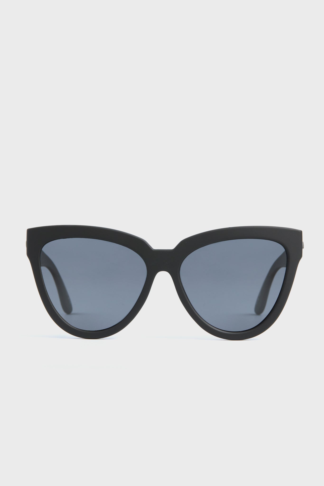 Le Specs black cat-eye sunglasses with dark tinted lenses, featuring an oversized design.