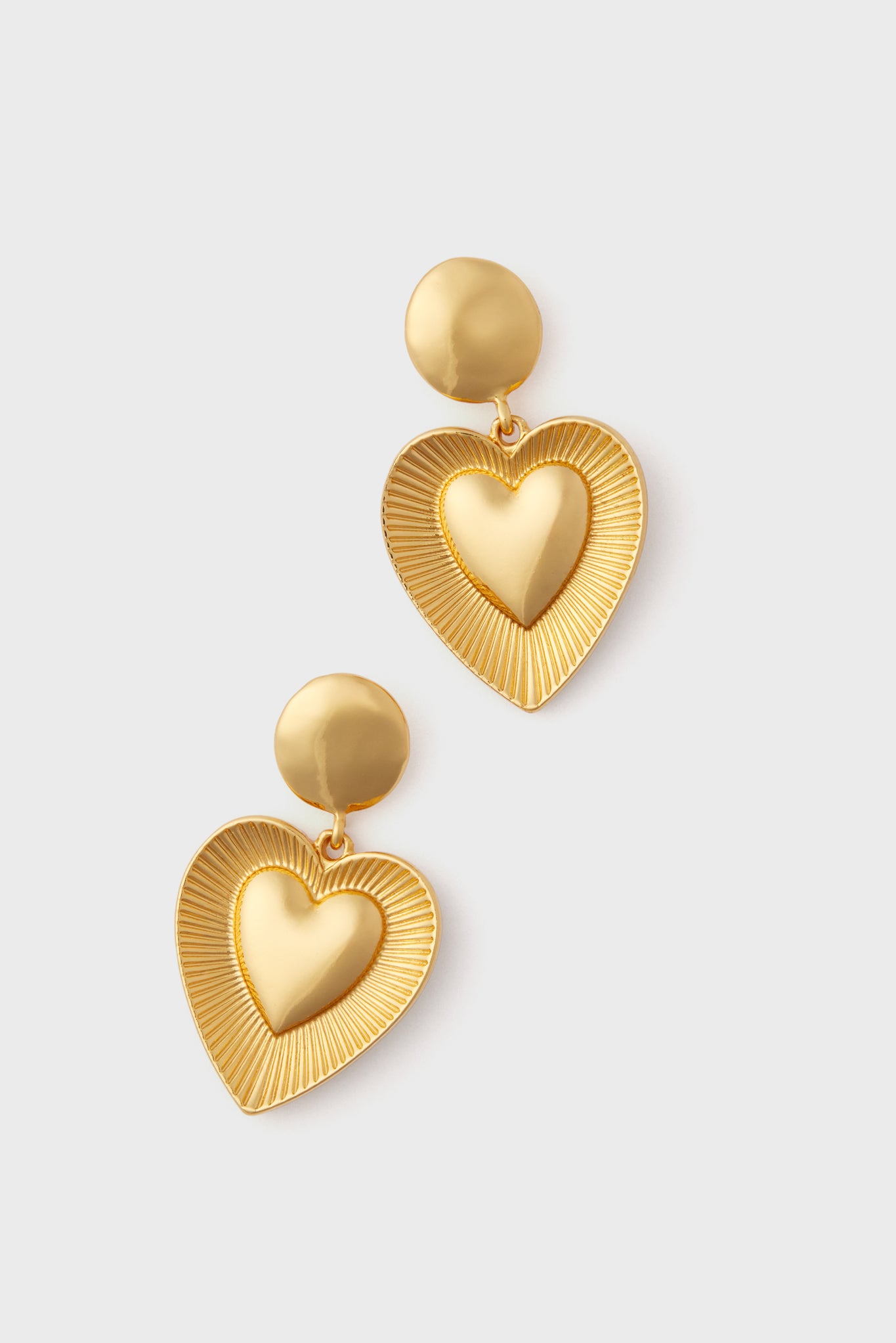 Explore the Petit Moments Gold Anna Earrings—vintage-inspired jewelry with gold-tone drops, round studs, and large textured heart-shaped pendants featuring a smooth center.