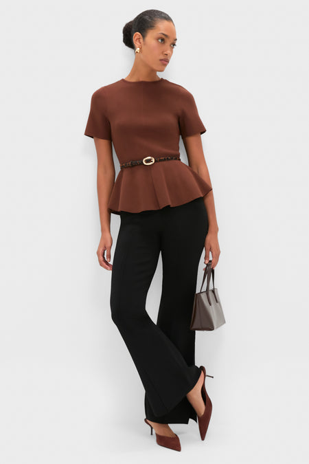 Woman wearing Black Hana Pull On Full Flare trousers with an effortless, fun and classic style, paired with a brown top, slingback heels, and a structured tote.
