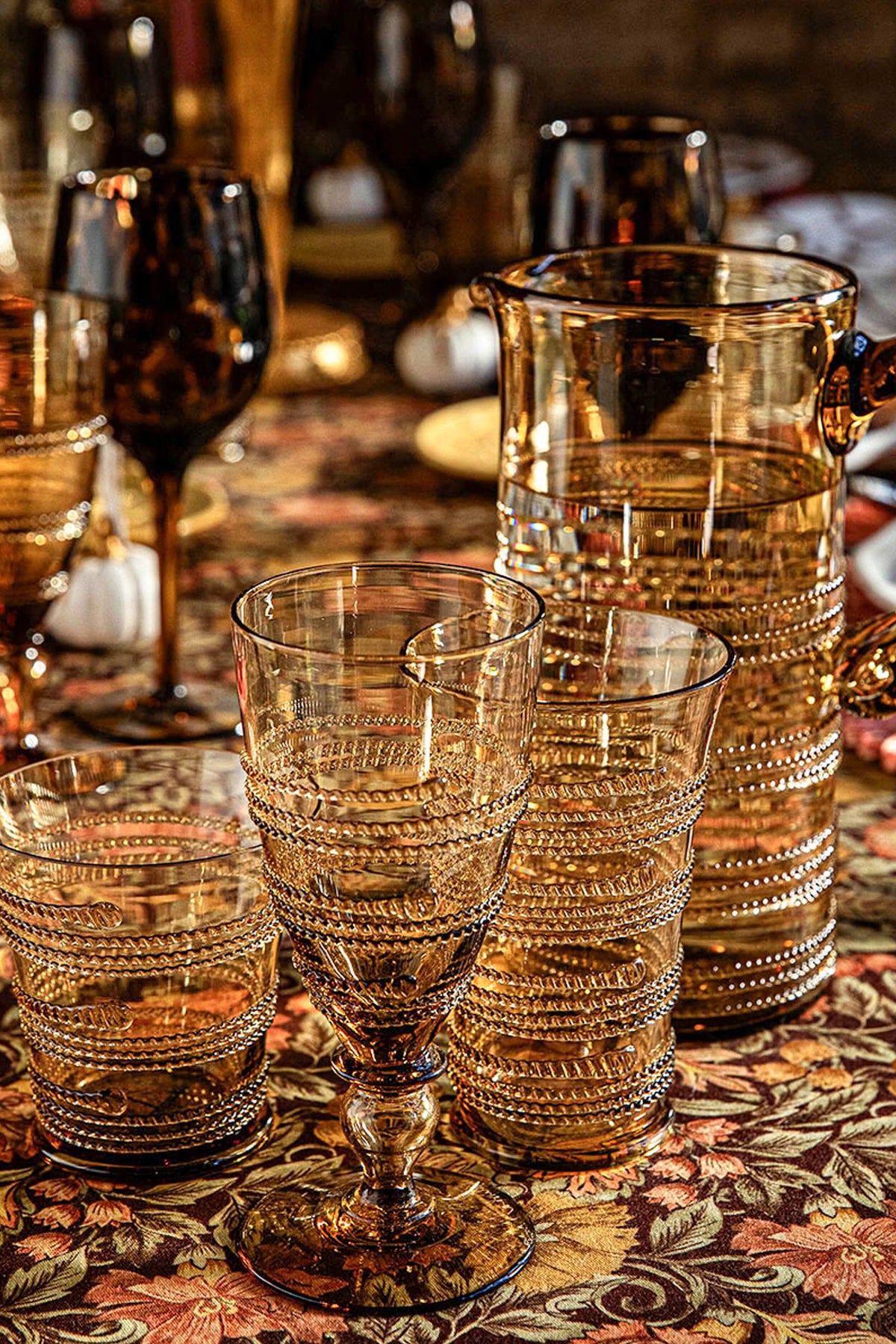 Amber Ella Goblet, a high-end, mouth-blown masterpiece, effortlessly sparkles with its ribbed, beaded glass design, perfect for adding classic elegance to any fun occasion.