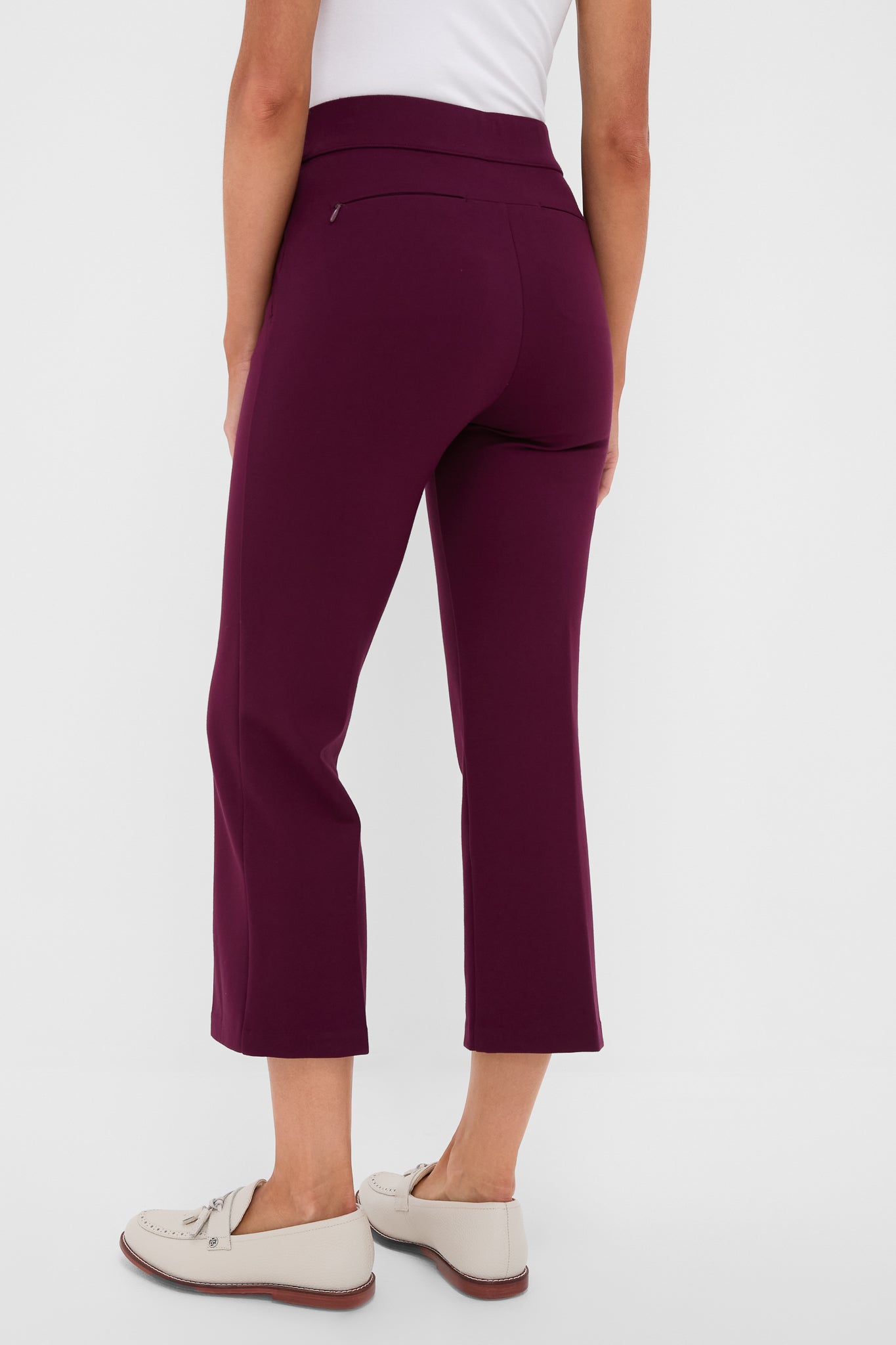 Back view of a person in Petite Winetasting Compression September Pant, showing classic cropped style with effortless elegance, paired with cream loafers and a tucked white top.