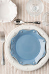 Chambray Berry & Thread Scalloped Dessert/Salad Plate in powder-blue, elegantly layered on an off-white charger, embodies classic, high-end style with effortless charm.