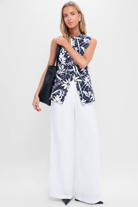 Model showcasing classic Black Eleanor Heels with pointed toes and block heels, paired with an effortless ensemble of navy top and white trousers, exuding a high-end, fun vibe.