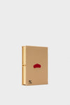 Latte Les Chiens Caramel Book Clutch, a classic, high-end book-shaped clutch with a camel-tan cover, red embroidery, and gold clasp, exuding effortless elegance and fun.