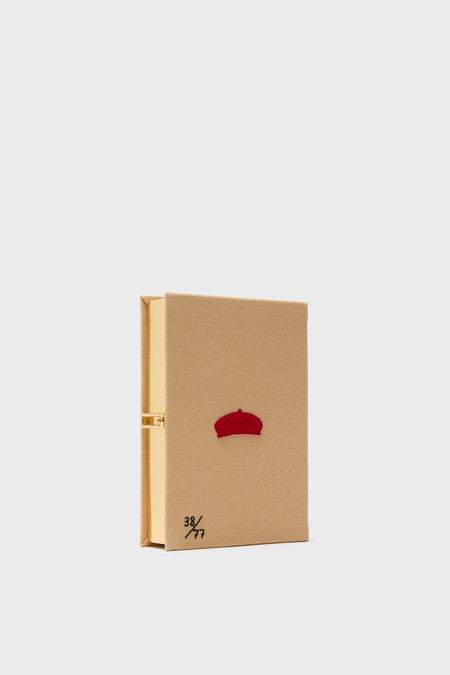 Latte Les Chiens Caramel Book Clutch, a classic, high-end book-shaped clutch with a camel-tan cover, red embroidery, and gold clasp, exuding effortless elegance and fun.