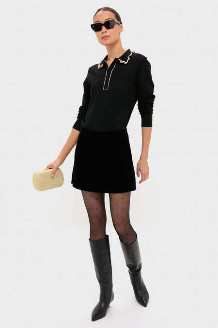 Model wearing Shiny Solid Black Corner Angle M Sunglasses, embodying a classic and effortless look with high-end, fun style, enhanced by oversized frames and chic outfit.