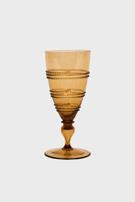Amber-colored, mouth-blown glass goblet by Juliska featuring a textured spiral design around the bowl, with a short stem and circular base.