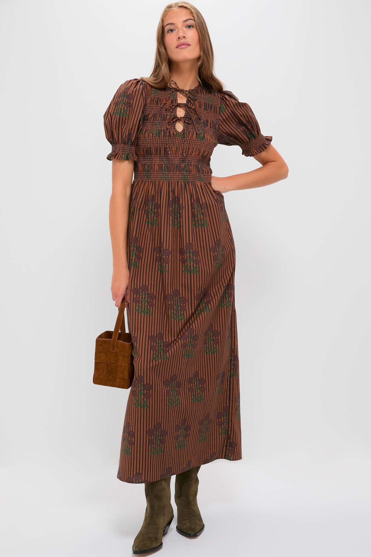 Model wears the Multi Maribel Maxi Dress, featuring classic short puff sleeves, a smocked waist, and an effortless lace-up neckline, styled with fun suede accessories.