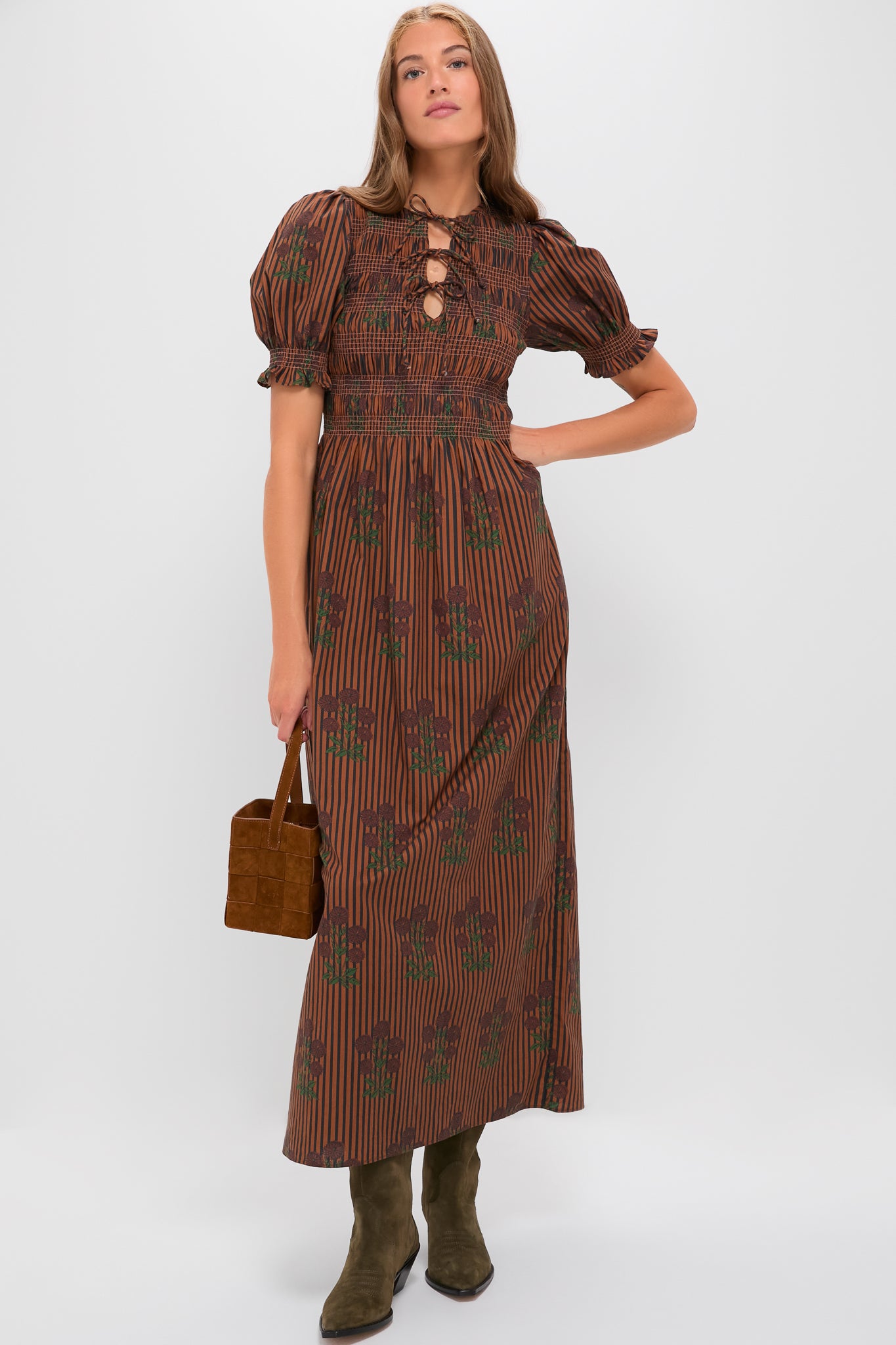 Model wears the Multi Maribel Maxi Dress, featuring classic short puff sleeves, a smocked waist, and an effortless lace-up neckline, styled with fun suede accessories.