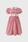 Classic Candy Cane Stripe Smocked Dress with red and white stripes, effortless puff sleeves, fun gingerbread and candy cane motifs, and a high-end Peter Pan collar.