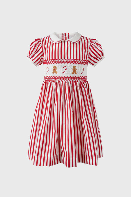 Classic Candy Cane Stripe Smocked Dress with red and white stripes, effortless puff sleeves, fun gingerbread and candy cane motifs, and a high-end Peter Pan collar.