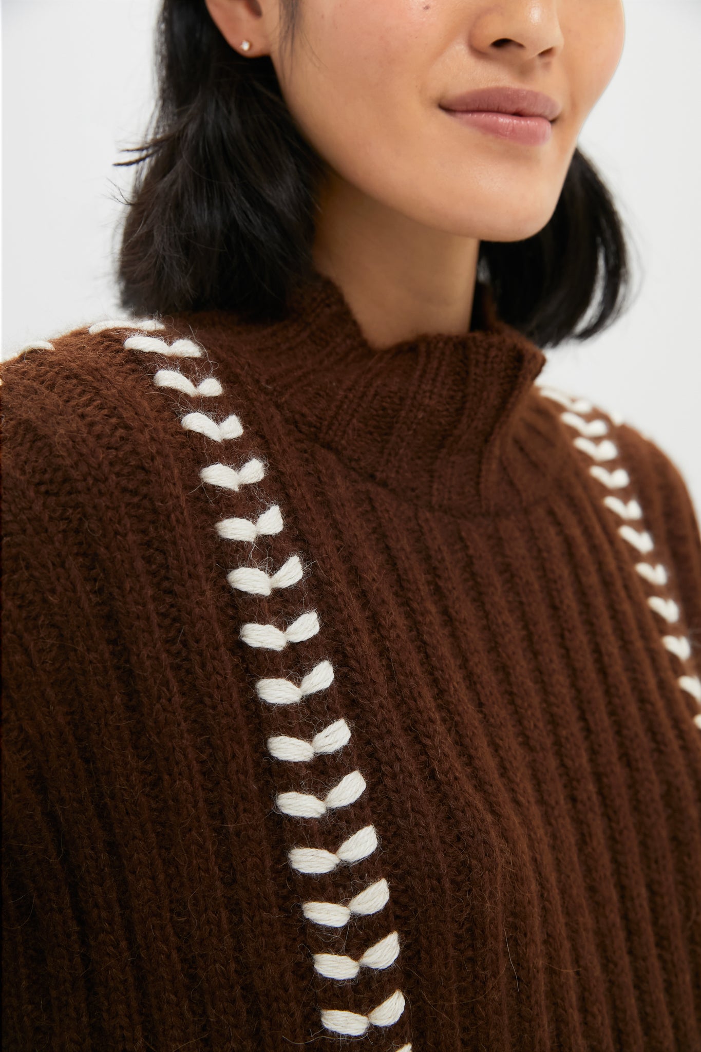 Brown Mayu Sweater with classic mock neck and fun leaf-shaped embroidery, offering effortless style with its high-end, ribbed-knit texture and chic artisanal details.
