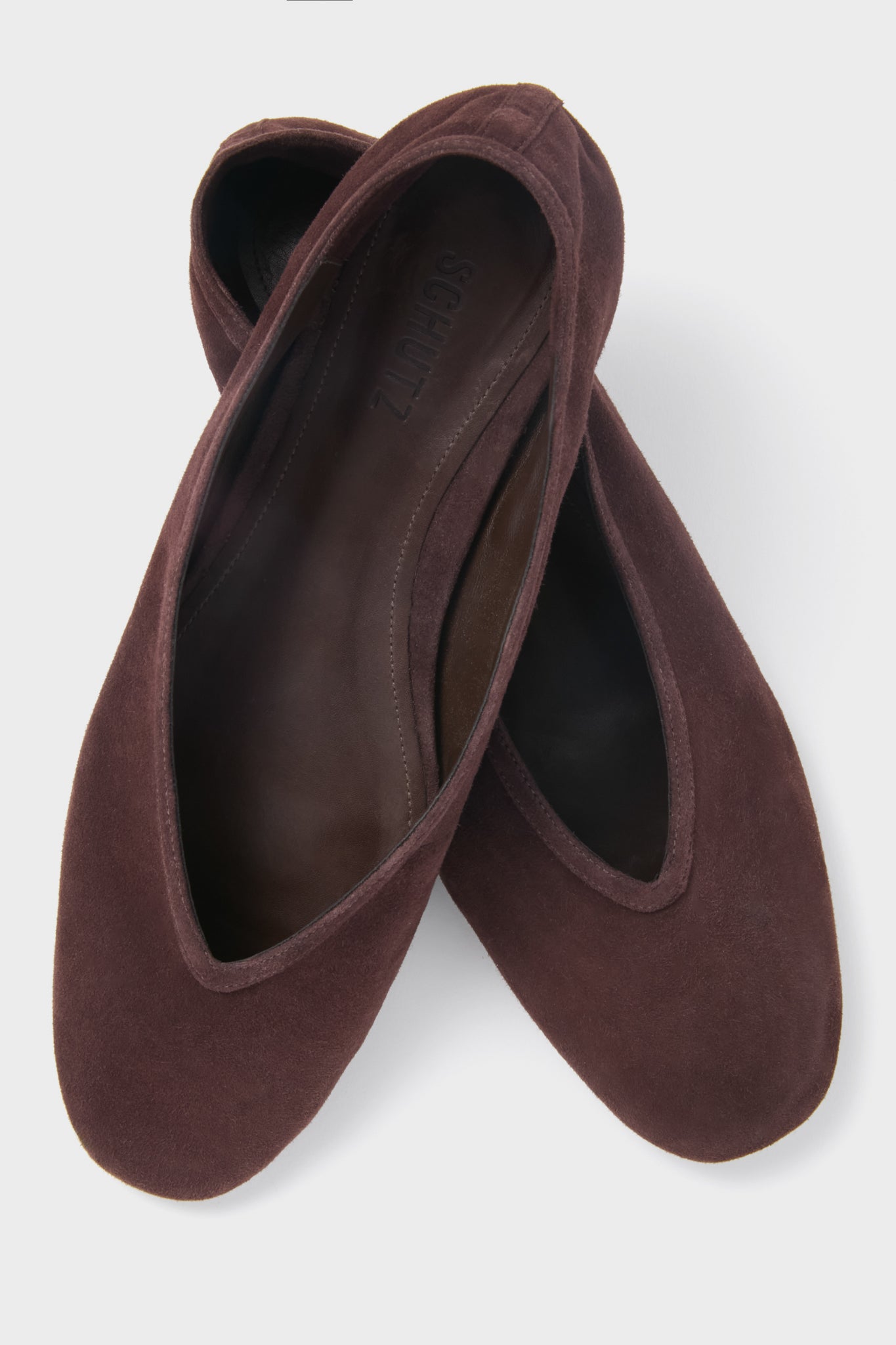 Seal Brown Courtney Flats in brown suede, featuring a classic slip-on design with a softly pointed toe and low-cut topline, exude effortless, high-end style.