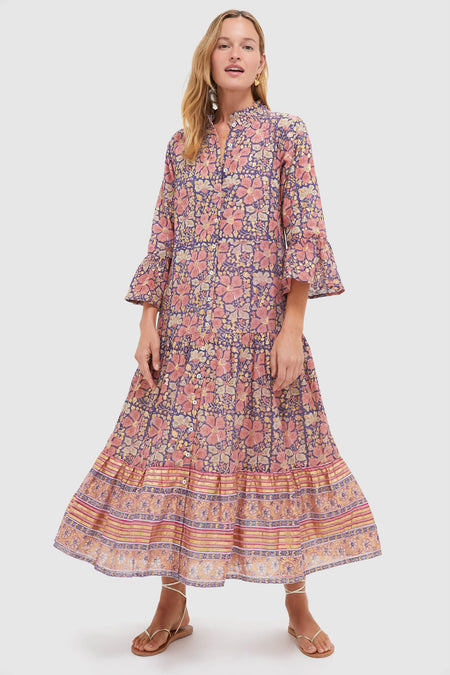 Woman modeling the classic Matera Navy Ruffle Collar Bell Maxi Dress with floral print, ruffle accents, and tiered skirt; effortlessly elegant and high-end for fun events.