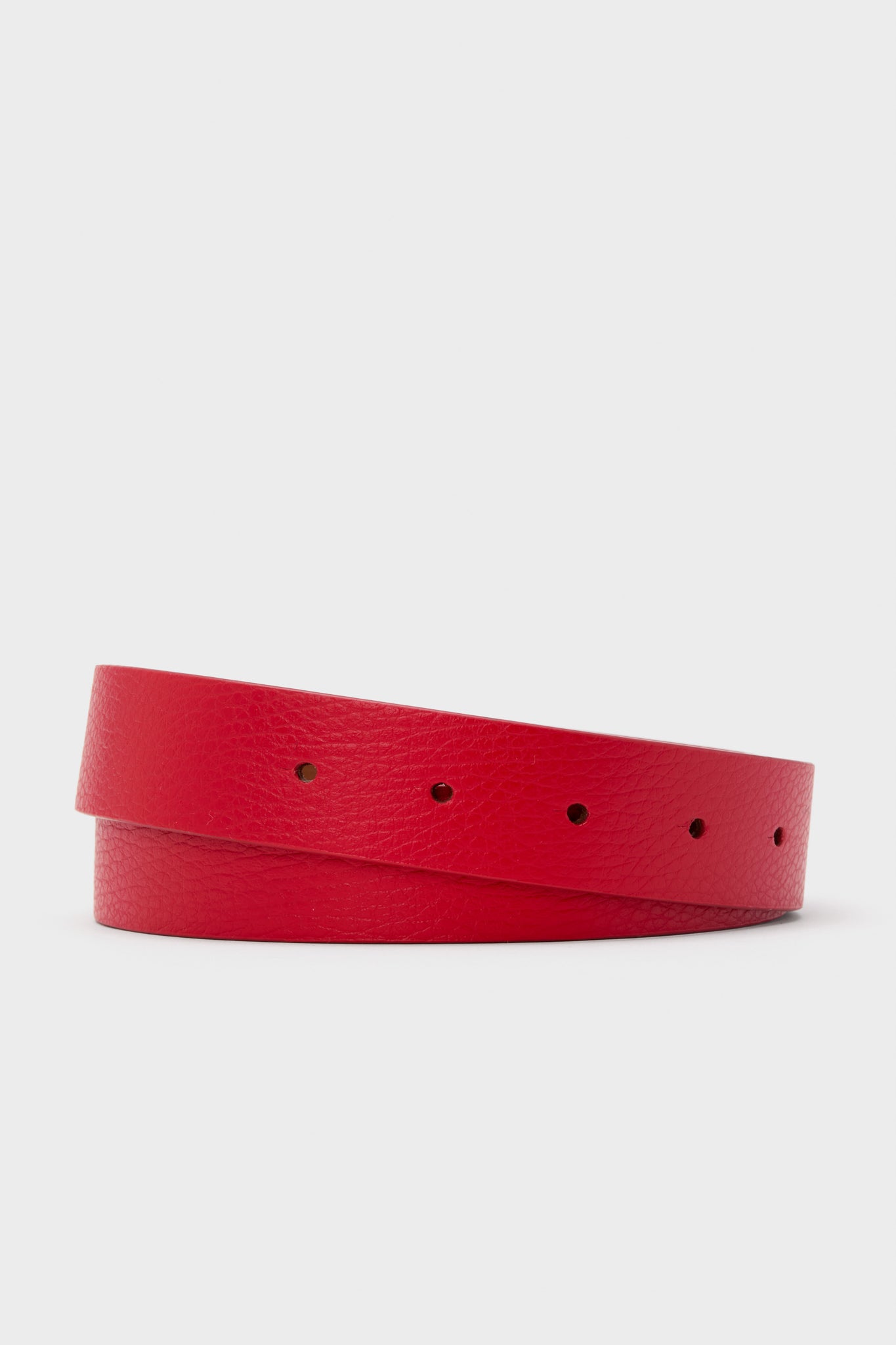 A Cesoli coiled red leather belt with a textured pebble-grain finish and multiple holes, crafted from Italian leather, is displayed.