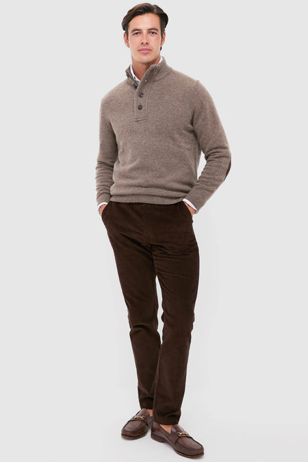 Model in classic autumn-ready outfit featuring Dark Stone Essential Patch Half Zip Knitted Jumper, showcasing effortless, high-end style with fun leather elbow patches and smart-casual layering.