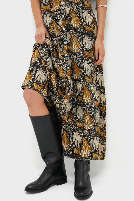 Person wearing the Story Print Santiago 3 Maxi Dress with a classic animal and foliage print, revealing leg and paired with effortless, high-end leather boots for a fun, stylish look.